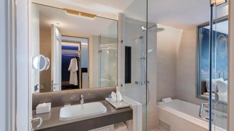 a bathroom with a sink and a shower and a tub at Grande Centre Point Surawong Bangkok in Bangkok