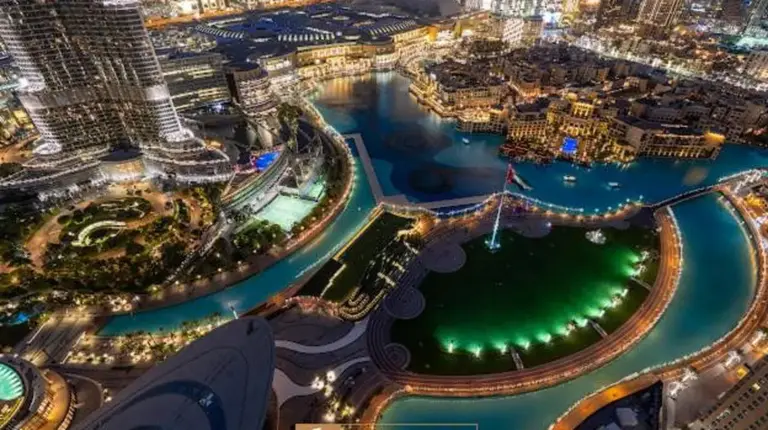 an aerial view of a city at night at Grande Signature Residences in Dubai