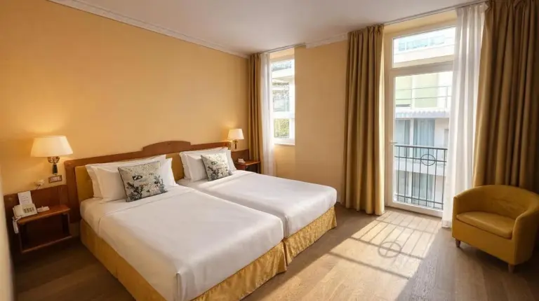 a hotel room with a large bed and a window at Greif Hotel & Spa in Trieste
