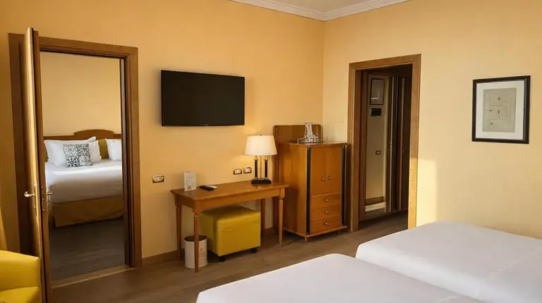 a hotel room with two beds and a television at Greif Hotel & Spa in Trieste