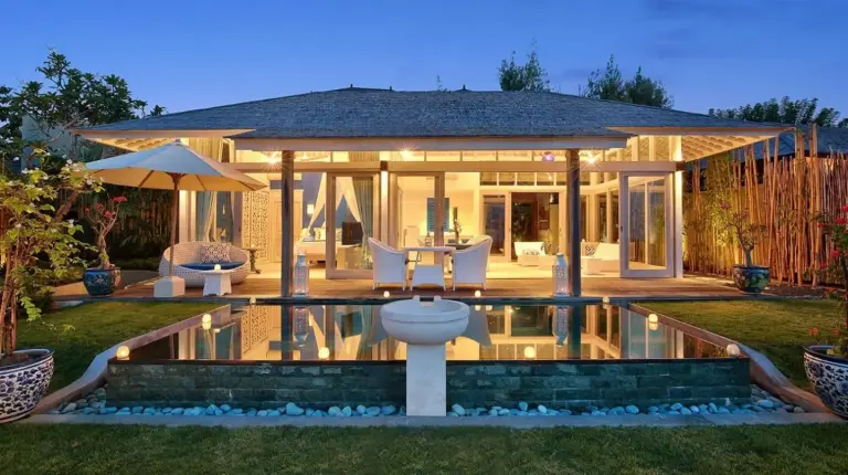 a house with a pool with a table and chairs at Hidden Hills Villas - Small Luxury Hotels of The World in Uluwatu