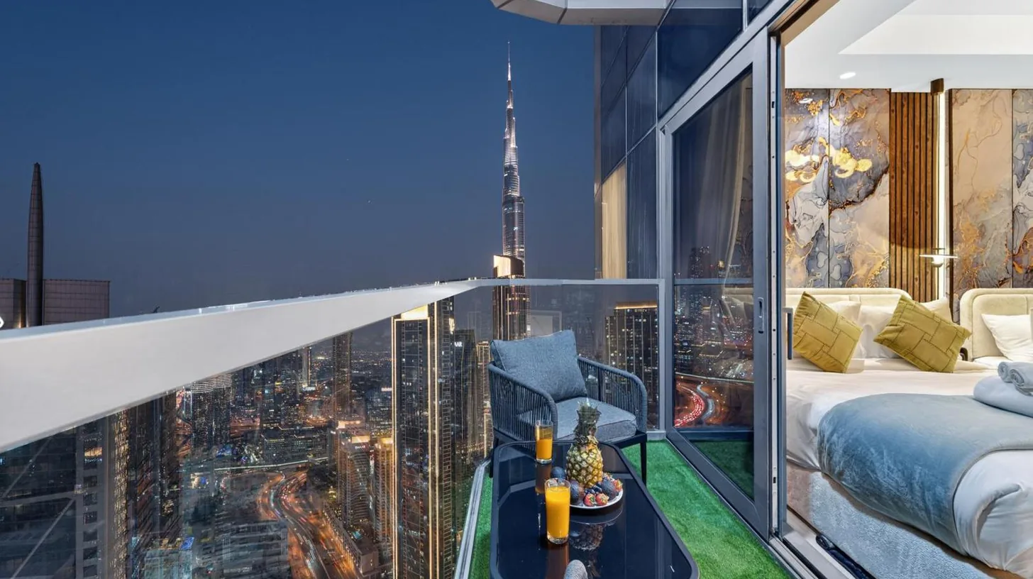 a bedroom with a view of a city at Highest Infinity Pool in Downtown Dubai in Dubai