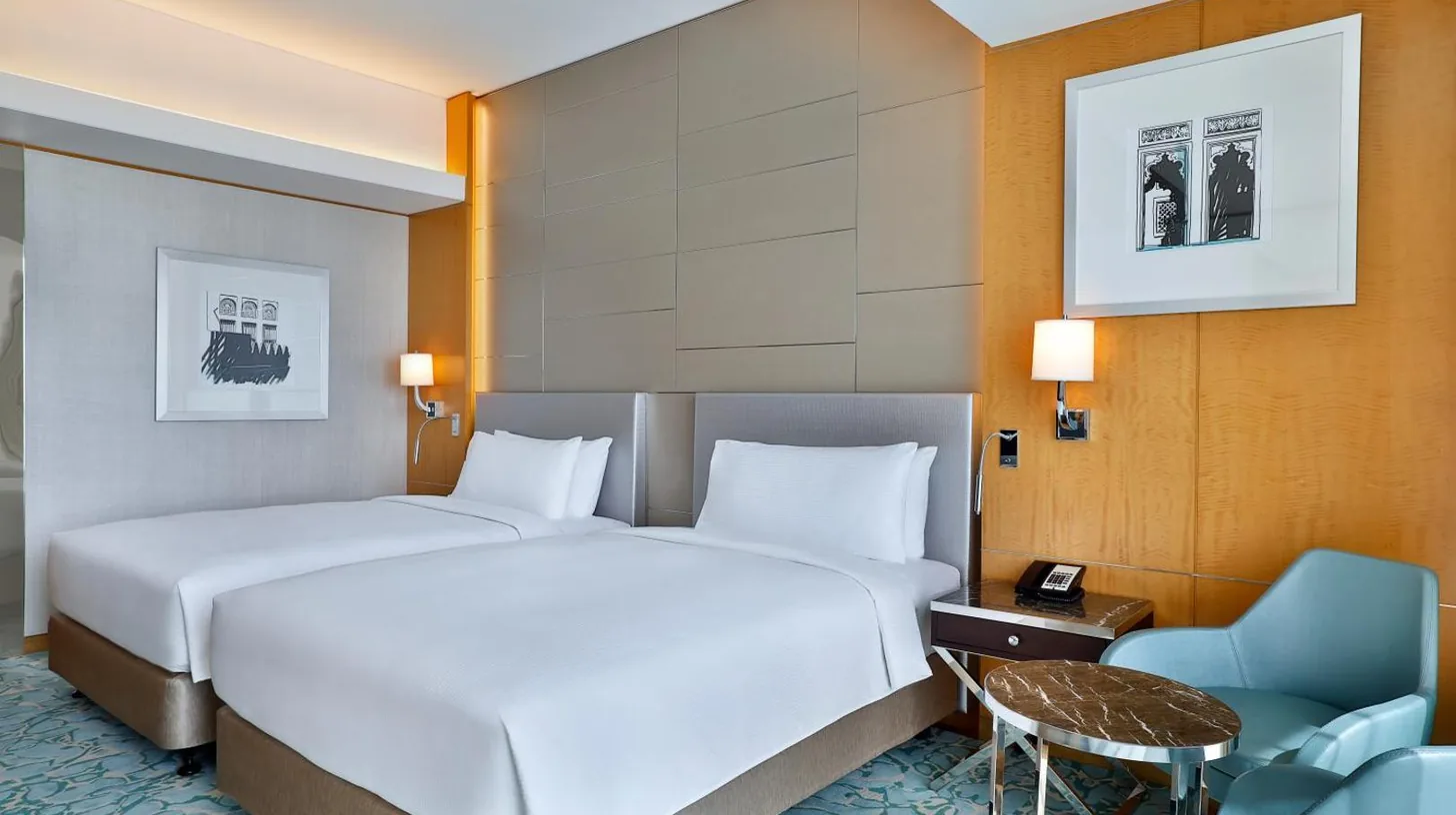 a hotel room with a bed and a chair at Hilton Dubai Palm Jumeirah in Dubai