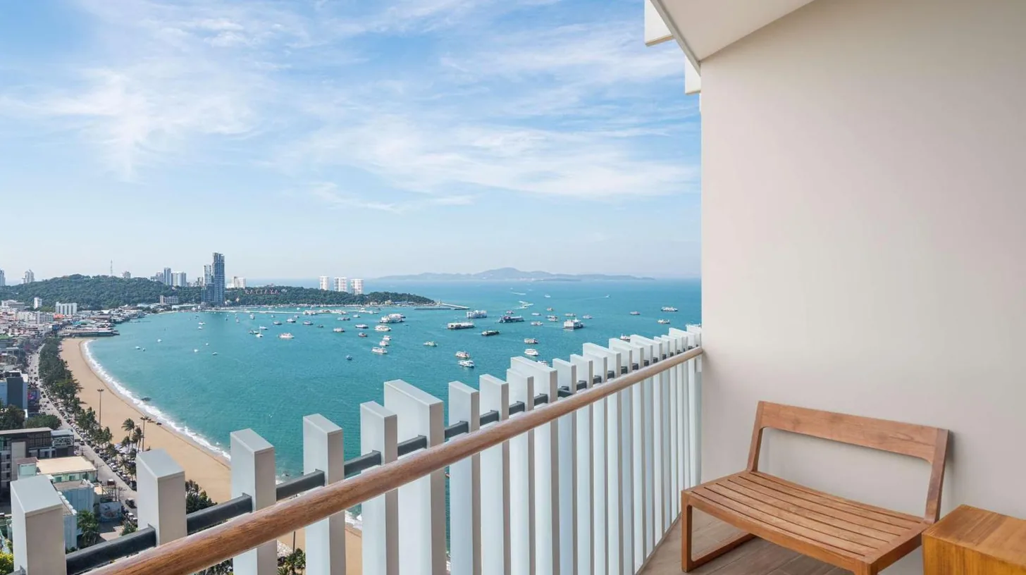a balcony with a view of a beach and the ocean at Hilton Pattaya in Pattaya Central