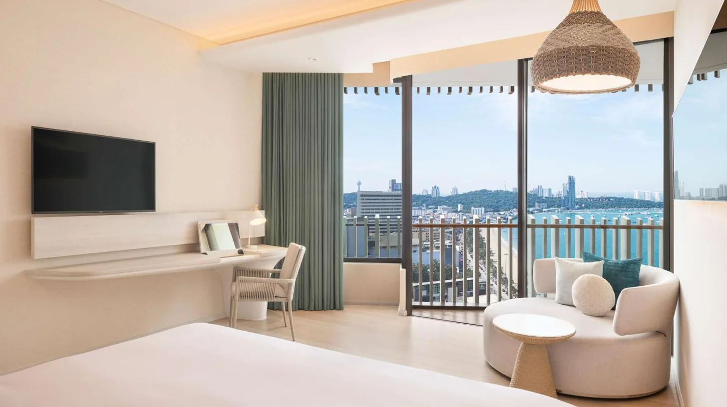a hotel room with a bed and a large window at Hilton Pattaya in Pattaya Central