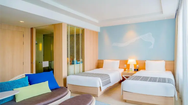 a bedroom with a large bed and two lamps at Holiday Inn Pattaya by IHG in Pattaya Central