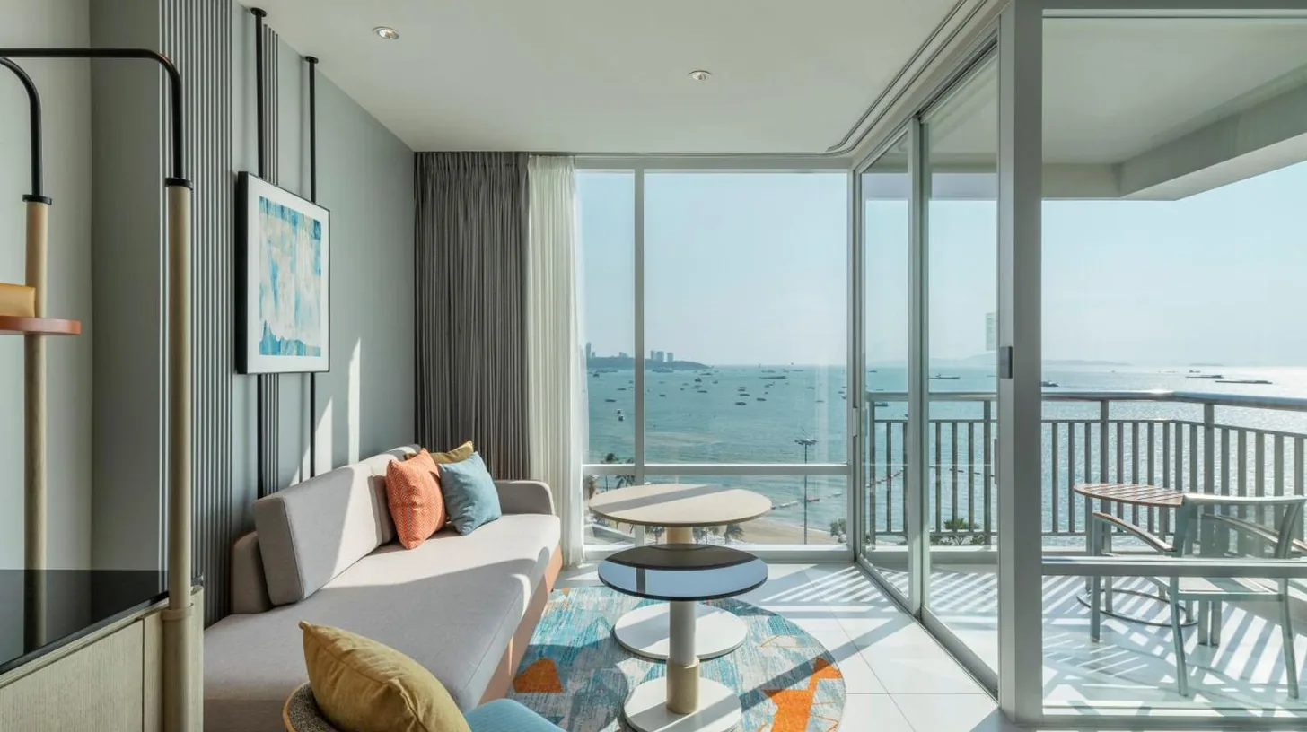 a bedroom with a bed and a view of the water at Holiday Inn Pattaya by IHG in Pattaya Central
