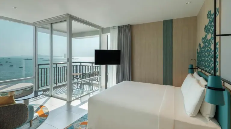 a room with a view of the beach from a hotel room at Holiday Inn Pattaya by IHG in Pattaya Central
