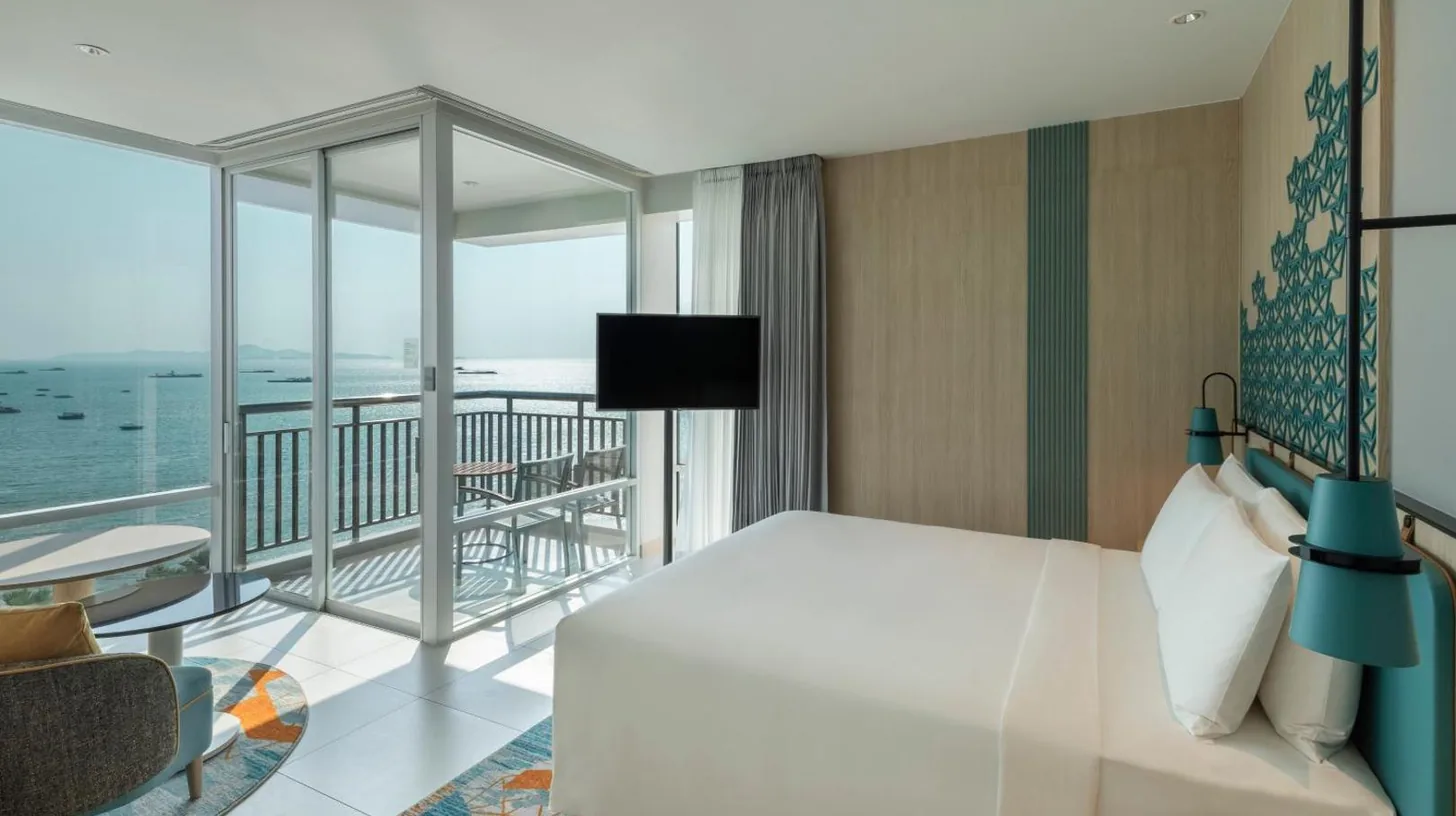 a room with a view of the beach from a hotel room at Holiday Inn Pattaya by IHG in Pattaya Central