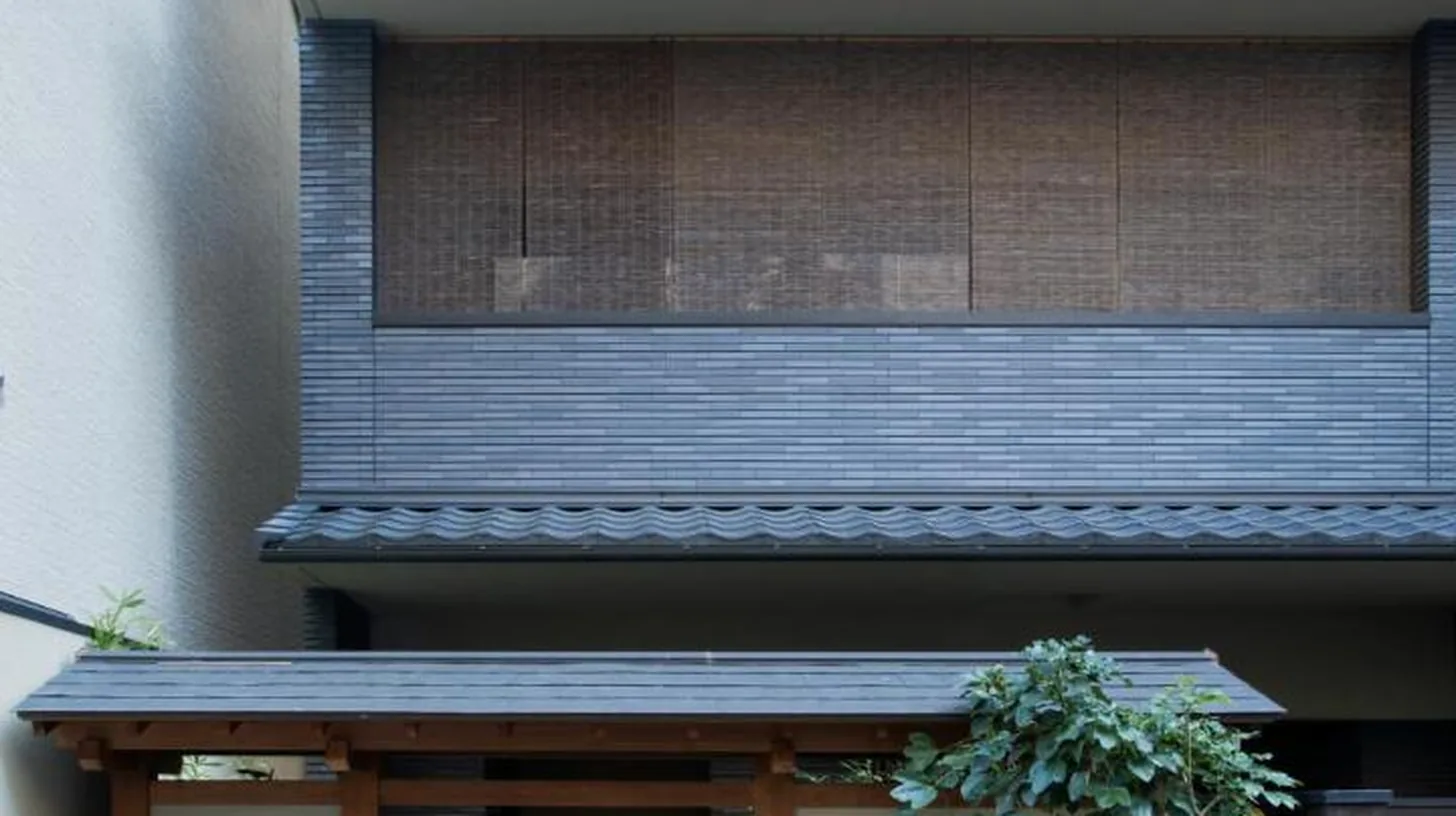 a building with a sign on the front of it at Homm Stay Nagi Shijo Kyoto By Banyan Group in Kyoto