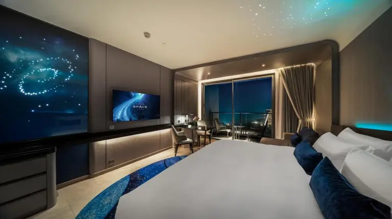 une chambre d'hôtel avec un grand lit et une télévision au Grande Centre Point Space Pattaya à Pattaya Nord