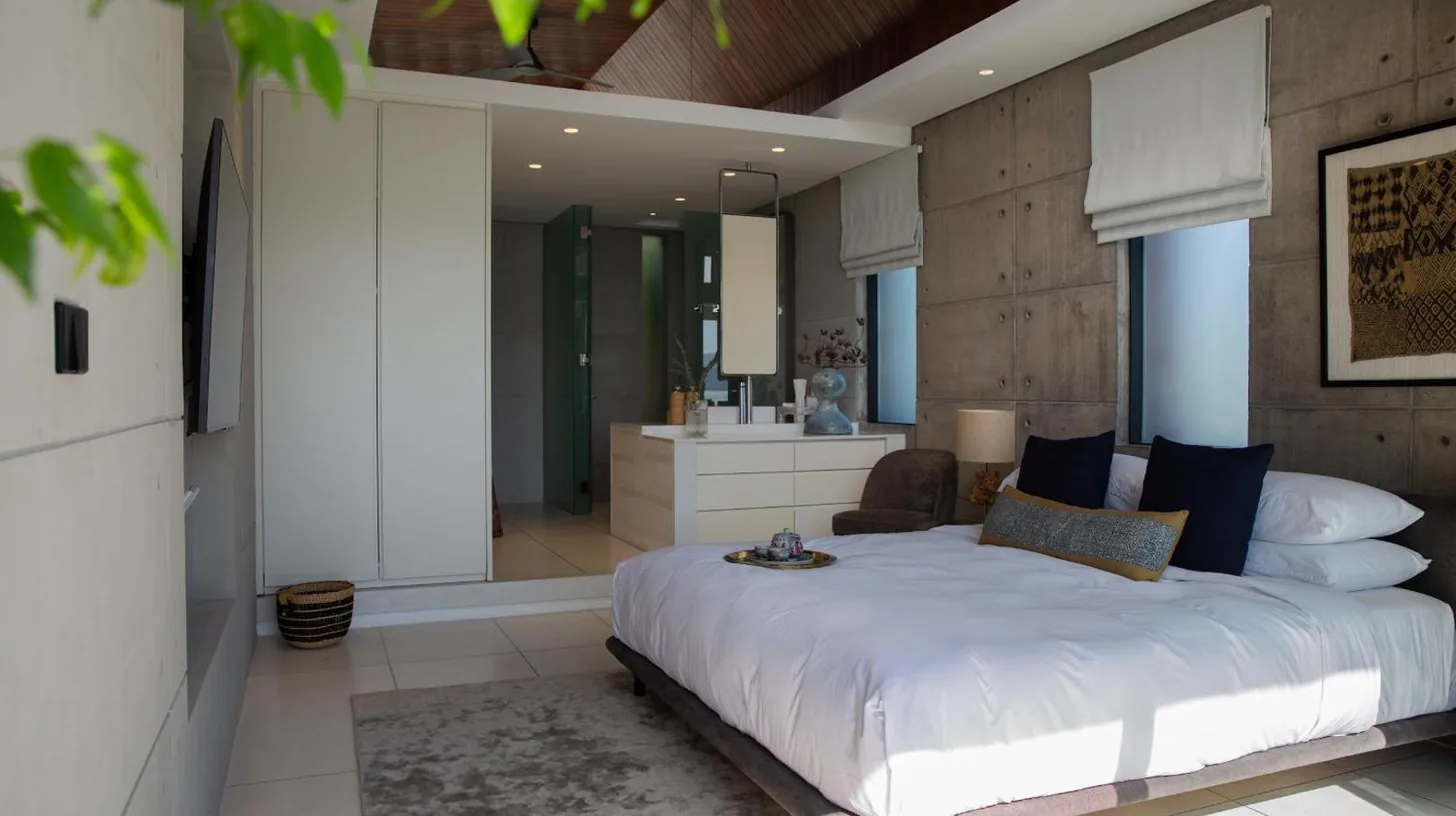 a bedroom with a large white bed and a bathroom at Kerem Luxury Beachfront Villas in Choeng Mon Beach