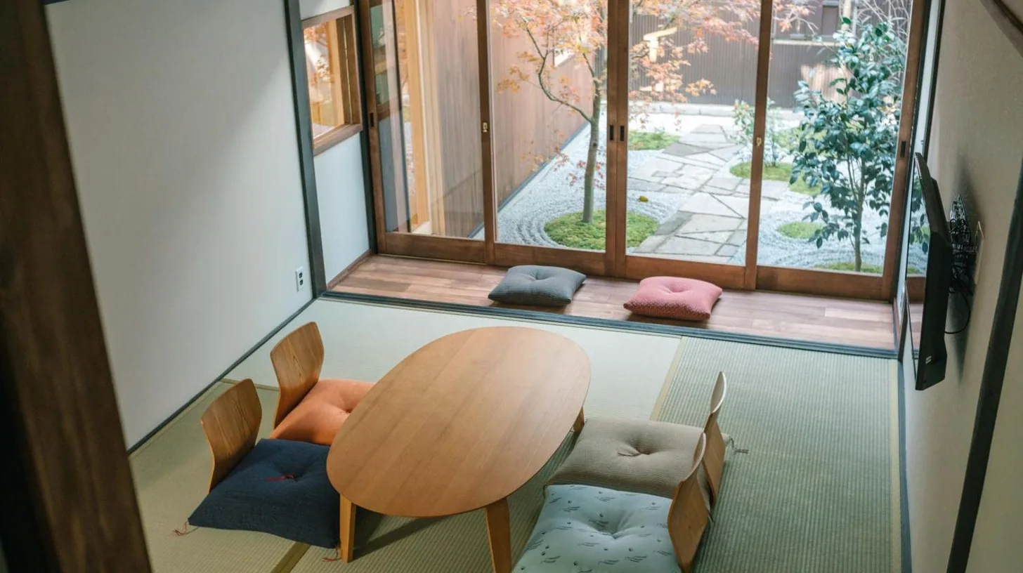 a room with a table and chairs and a window at Casa OGUMO in Kyoto