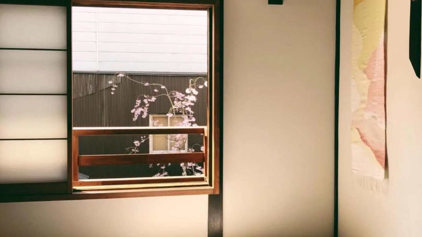 a bedroom with a white bed and a window at Casa OGUMO in Kyoto