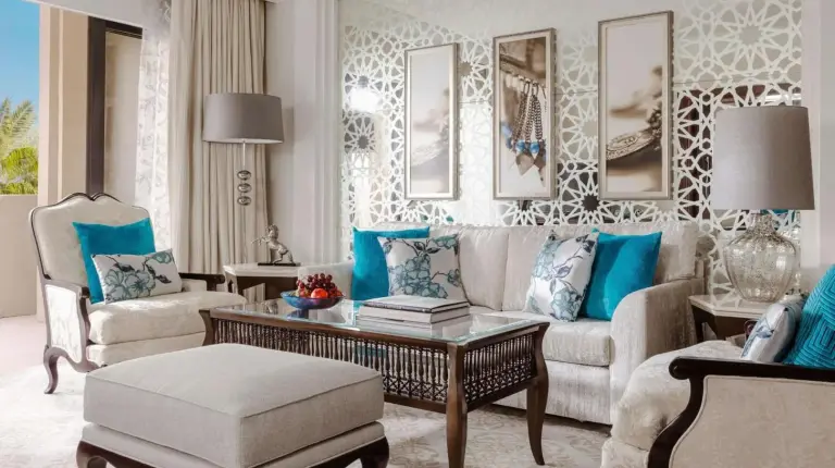a table with a vase with flowers on it at One&Only Royal Mirage Resort Dubai in Dubai