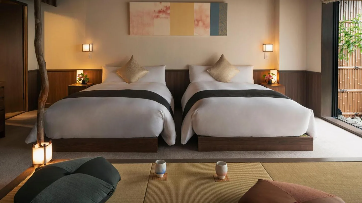two beds sitting in a room with at THE JUNEI HOTEL Kyoto Imperial Palace West in Kyoto