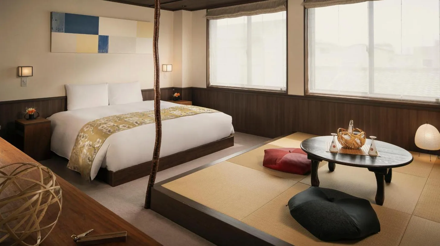 a hotel room with a bed and a table at THE JUNEI HOTEL Kyoto Imperial Palace West in Kyoto
