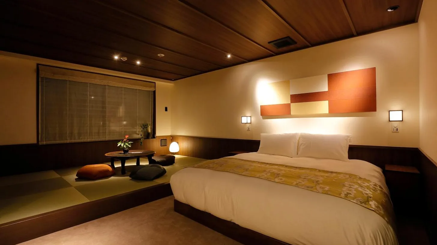 a bedroom with a large bed and a window at THE JUNEI HOTEL Kyoto Imperial Palace West in Kyoto