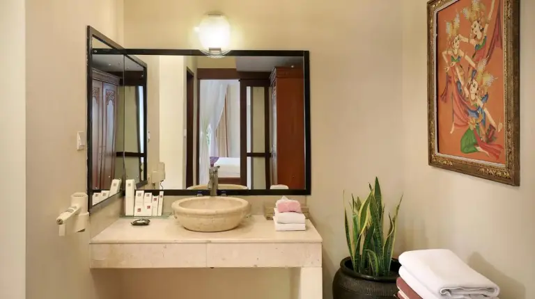 a bathroom with a sink and a large mirror at The Buah Bali Villas in Seminyak