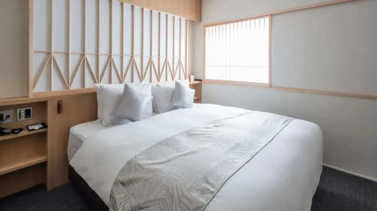 a hotel room with a bathroom with a bed at Tomoya Residence Hotel Kyoto in Kyoto