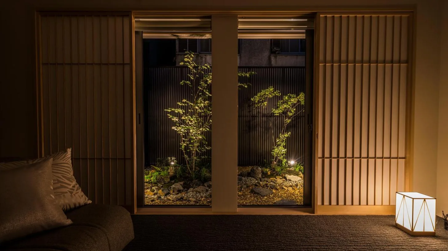 a jacket sitting on top of a bed at Tomoya Residence Hotel Kyoto in Kyoto