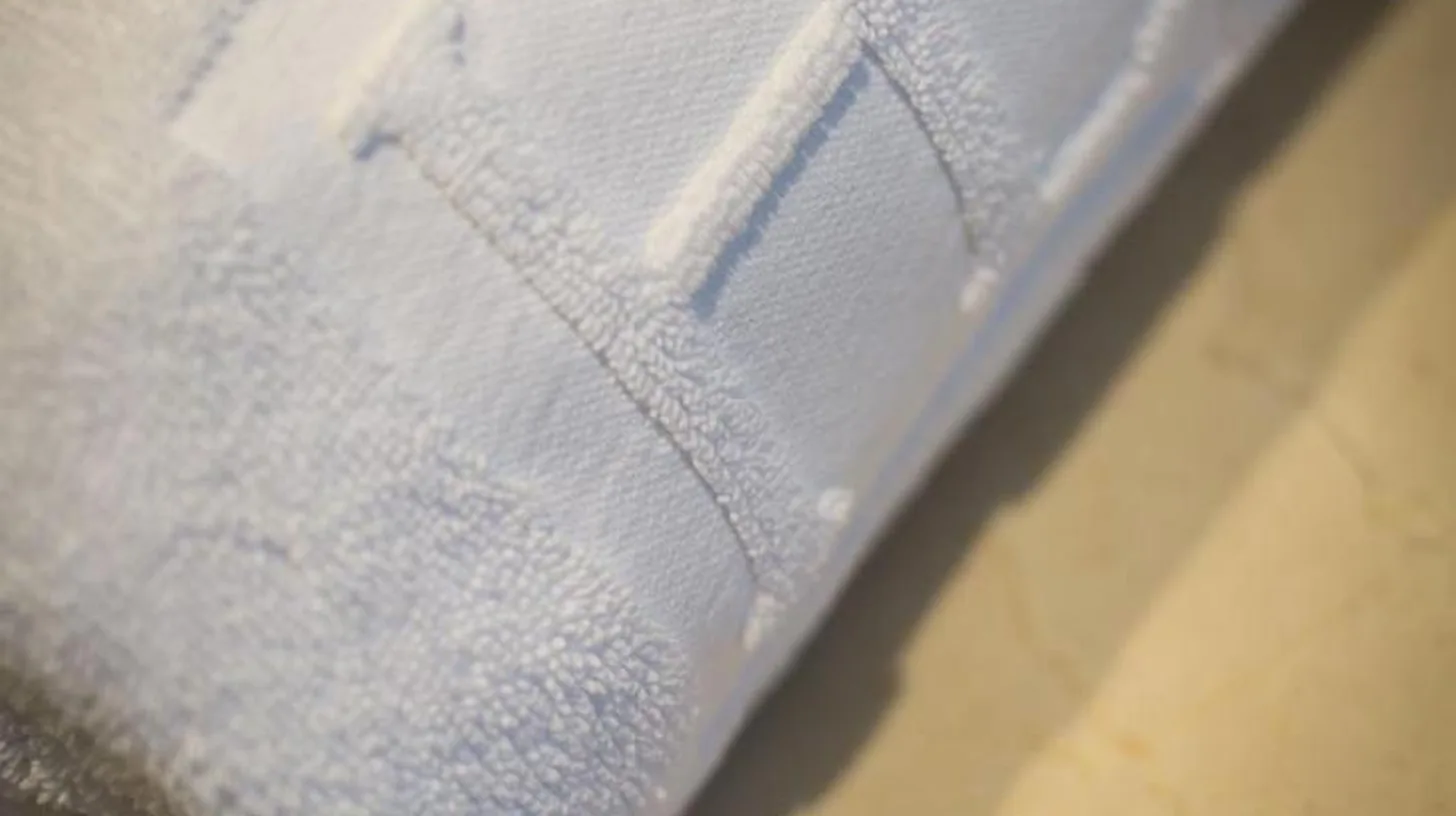a white napkin with the letter f on it at Hotel d'Europe in Avignon