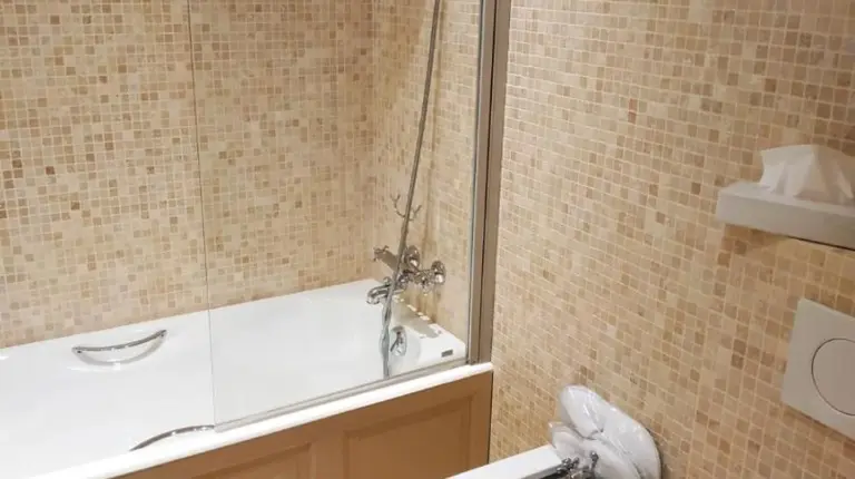 a bathroom with a tub and a toilet and a sink at Hotel d'Europe in Avignon