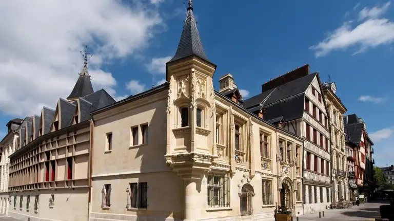 a building with a clock tower on top of it at Hôtel de Bourgtheroulde