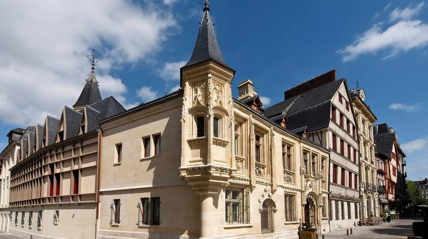 a building with a clock tower on top of it at Hôtel de Bourgtheroulde