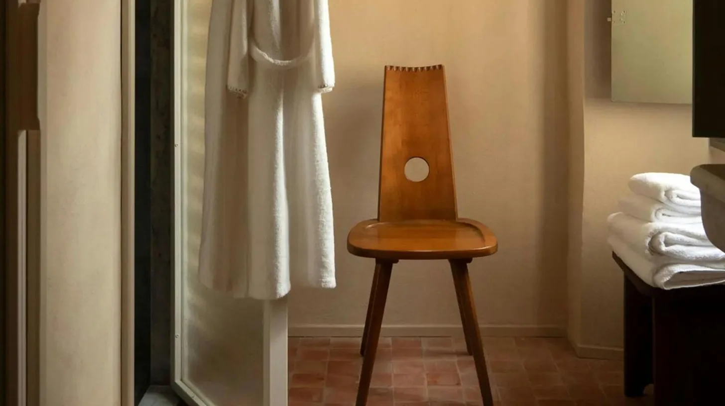 a bedroom with a bed and a chair and a couch at HÃ´tel du Couvent