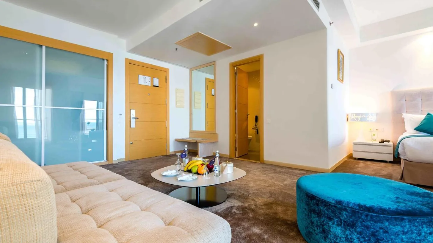 a living room with a couch and a table at Hotel Farah Tanger in Tangier