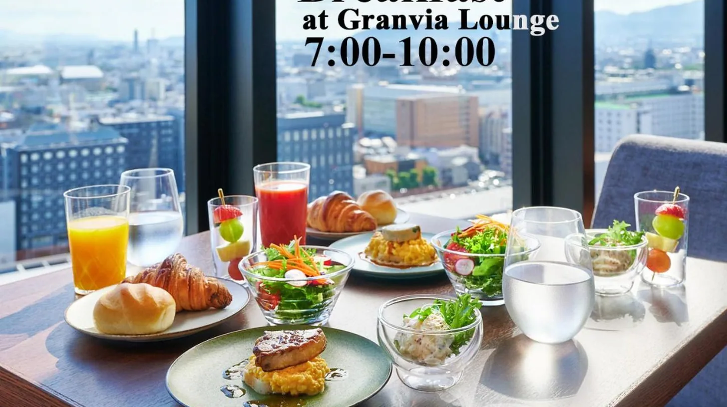 a table topped with a plate of food with cupcakes at Hotel Granvia Kyoto in Kyoto
