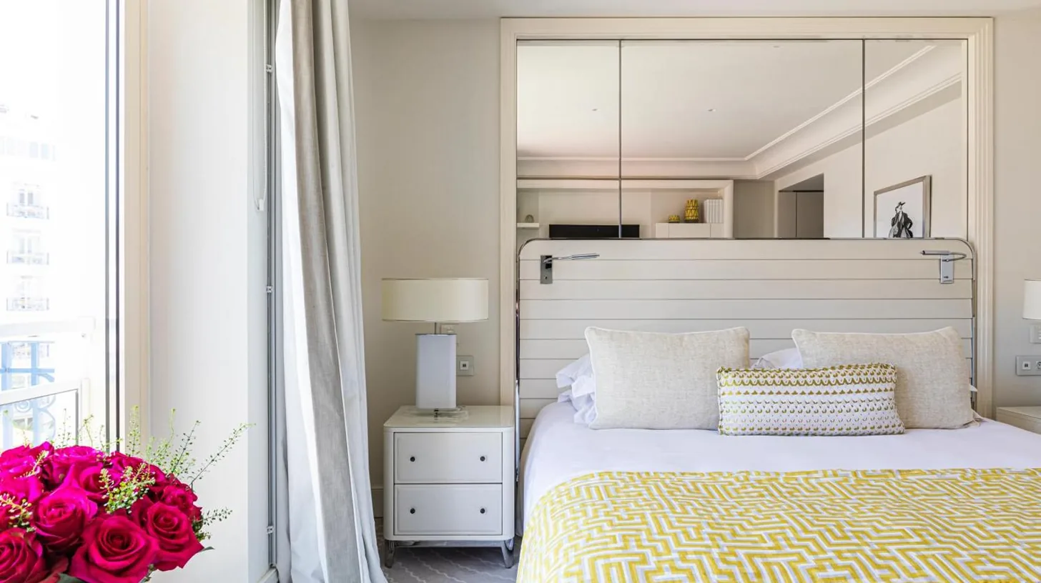 a bedroom with a large bed with two lamps at HÃ´tel Martinez