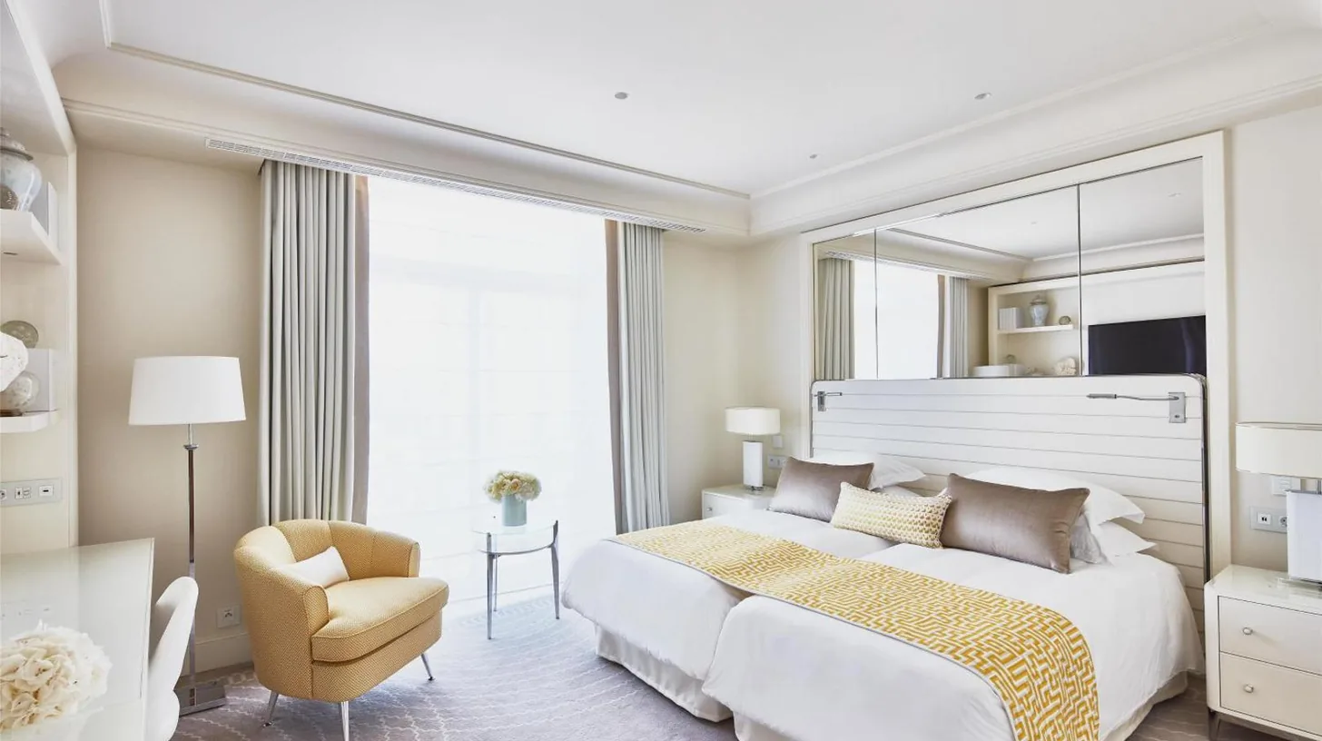 a bedroom with a large bed with a large mirror at HÃ´tel Martinez