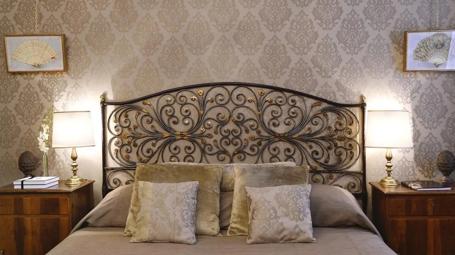a bedroom with a bed with a large mirror at Hotel Metropole Venezia in Venice
