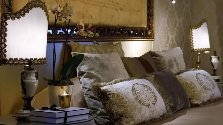 a bedroom with a bed with a large mirror on the wall at Hotel Metropole Venezia in Venice