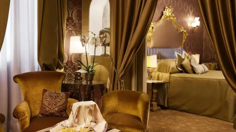 a bathroom with a sink with towels and a mirror at Hotel Metropole Venezia in Venice