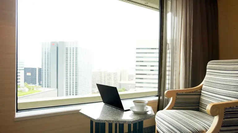 a hotel room with a large bed and a table at Hotel New Otani Osaka in Osaka