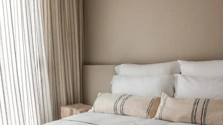 a bedroom with a large bed with a window at Hôtel & Spa Belle Plage in Cannes
