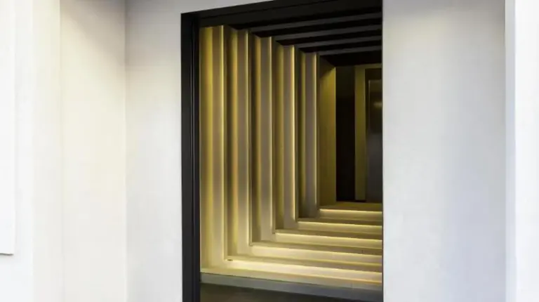 a entrance to a building with a yellow elevator at Hôtel & Spa Belle Plage in Cannes