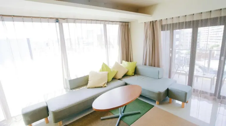a living room with a couch and a table at HOTEL Viviana in Naha
