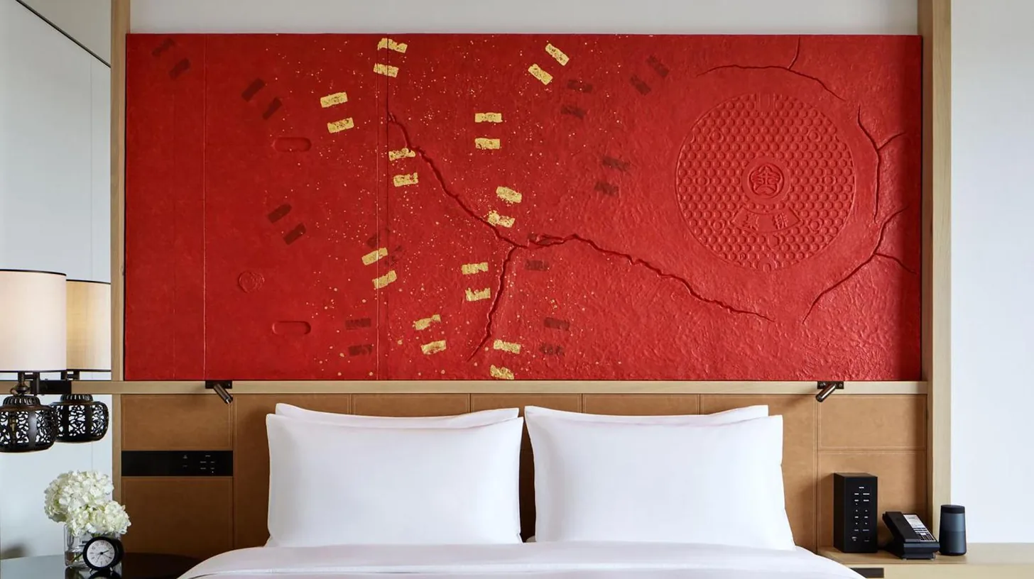 a bedroom with a large red painting above a bed at Hyatt Centric Kanazawa in Kanazawa