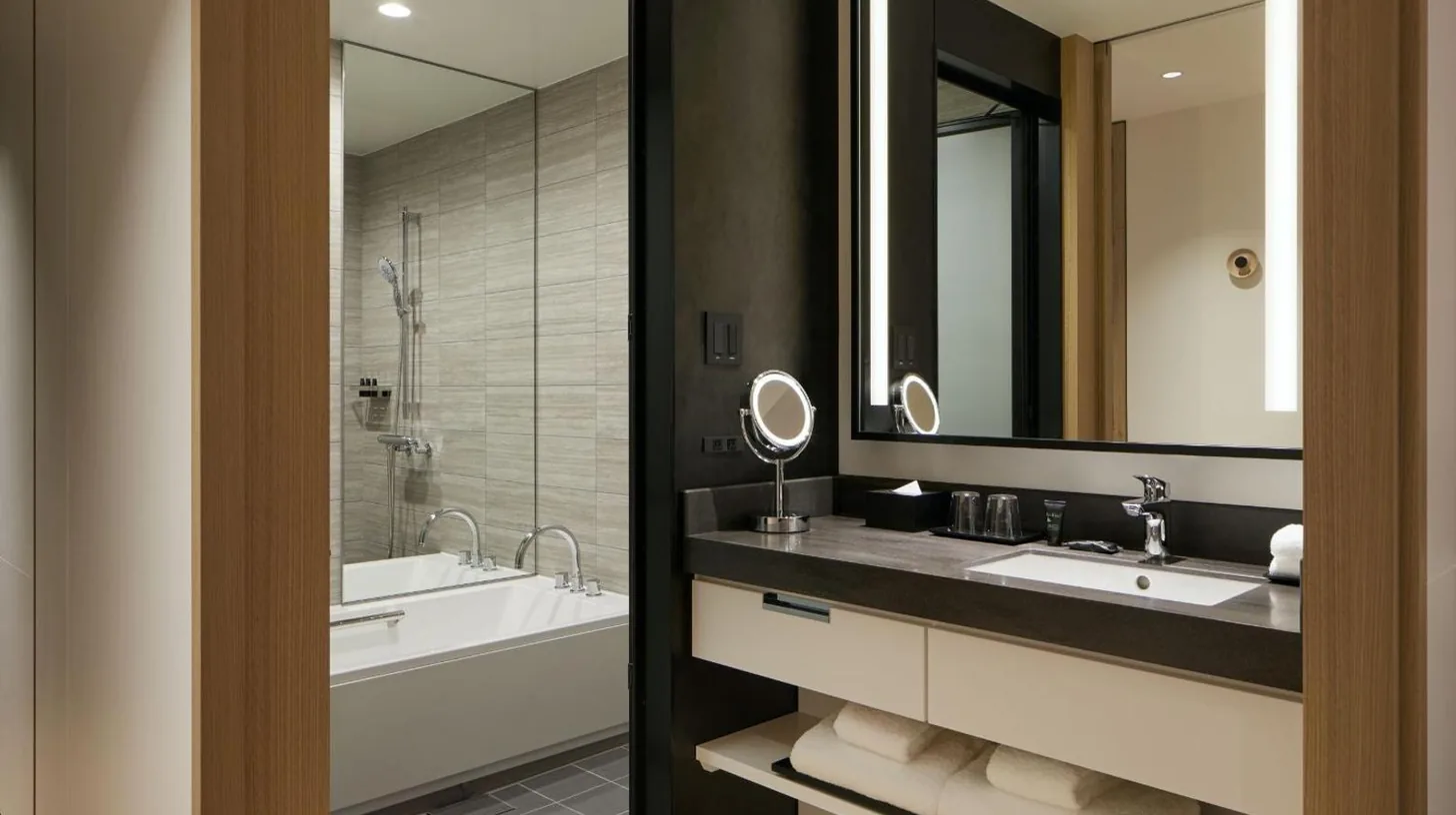 a bathroom with two sinks and a large mirror at Hyatt Centric Kanazawa in Kanazawa
