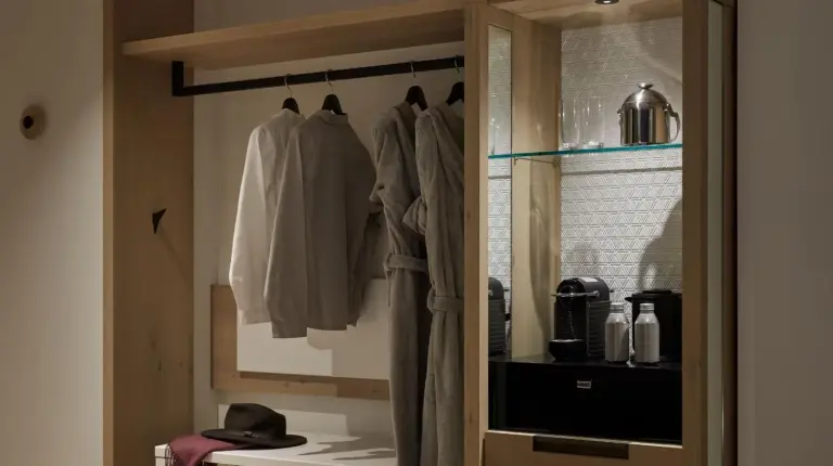 a kitchen with a closet with clothes hanging from it at Hyatt Centric Kanazawa in Kanazawa
