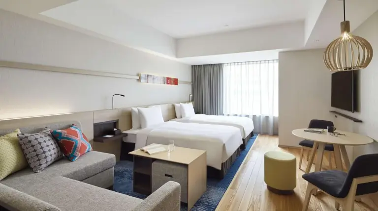 a kitchen and living room with a table and chairs at Hyatt House Kanazawa in Kanazawa