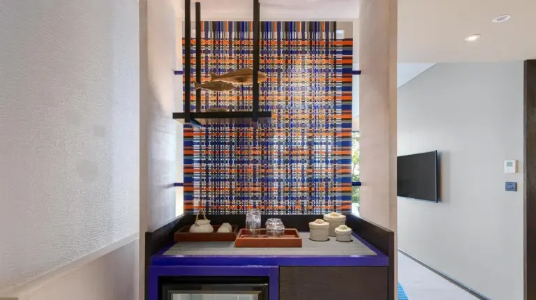 a chef standing in a kitchen preparing food at Hyatt Regency Koh Samui in Chaweng