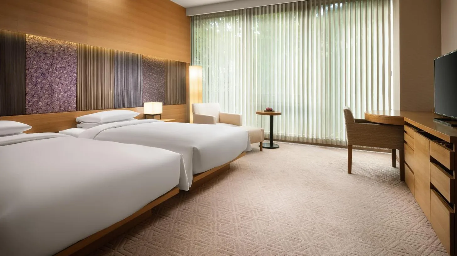 a large hotel room with a bed and a desk at Hyatt Regency Kyoto in Kyoto