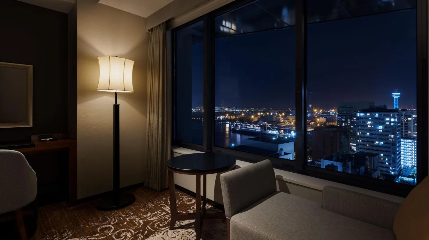 a hotel room with a view of a city at night at Hyatt Regency Yokohama in Yokohama