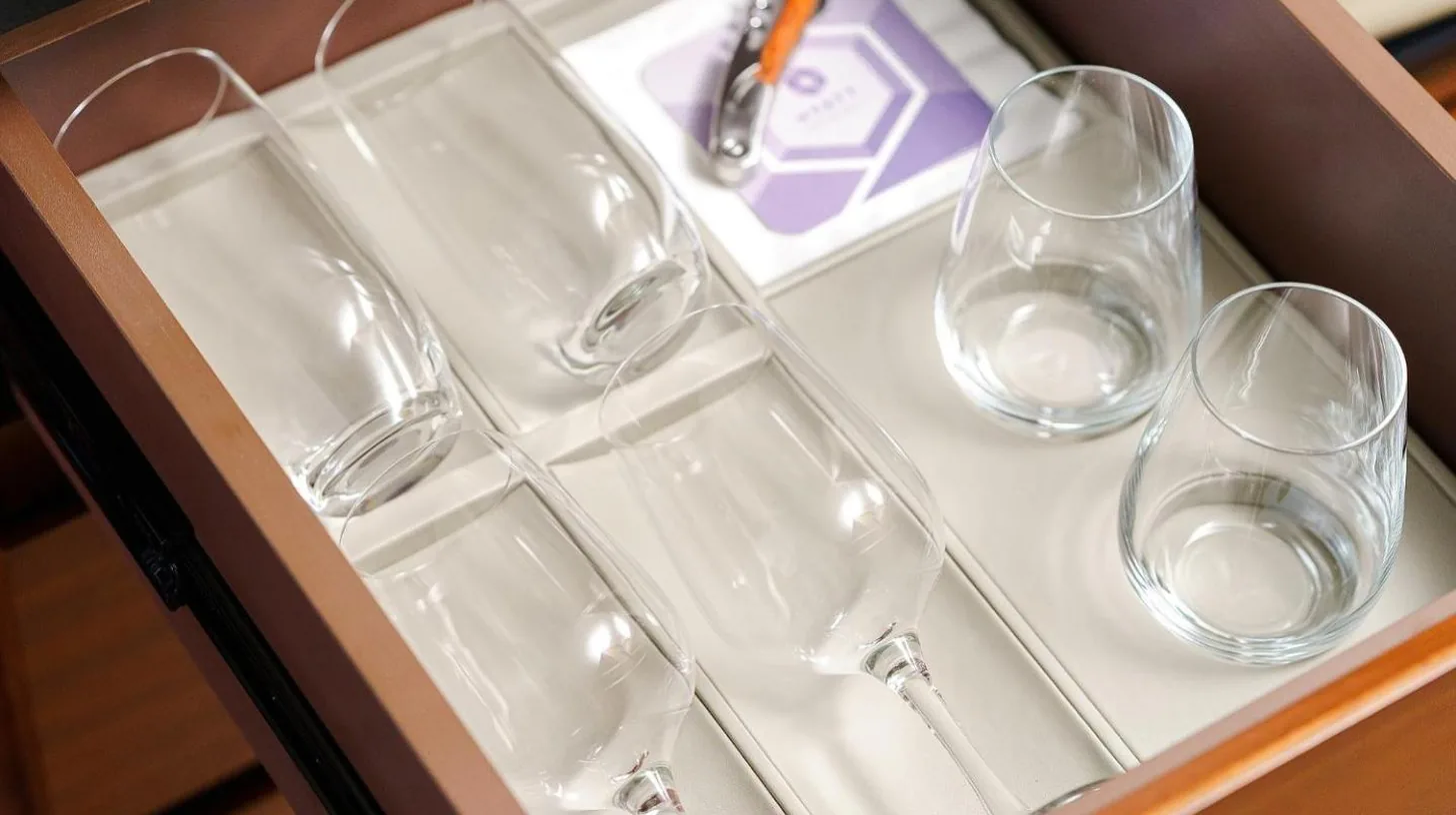 four empty wine glasses sitting on a tray at Hyatt Regency Yokohama in Yokohama