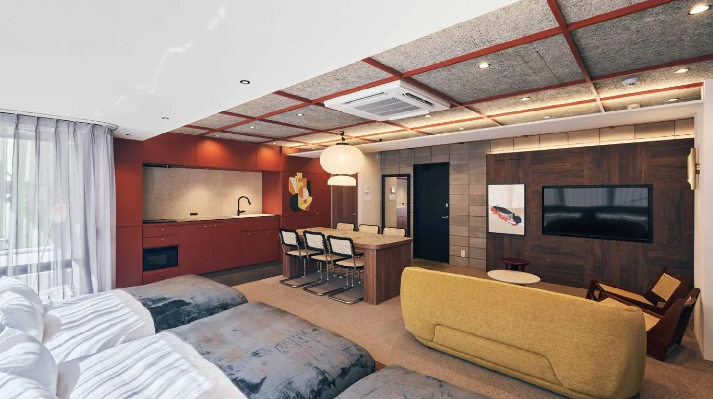a hotel room with two beds and a television at illi Jam Shinsaibashi in Osaka
